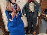 two dolls that are sitting on a chair together