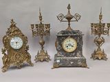 five different clocks and a candelab on a white background