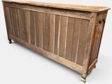 an old wooden chest with a wooden top and metal legs