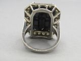 an image of a ring with a large black stone in it
