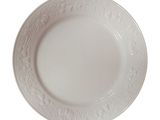 a white plate with a pattern on it on a white background