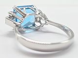 an image of a ring with a blue topazr and a diamond
