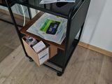 a small black cart with a computer on top of it