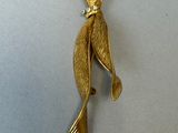 an image of a gold plated bird brooch with a diamond in its beak