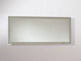 a mirror on the wall above a toilet in a bathroom