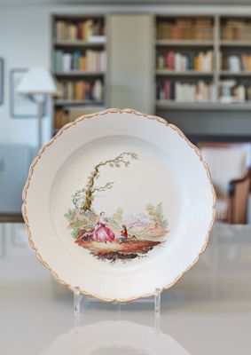 a plate that has a picture of a woman and a dog on it