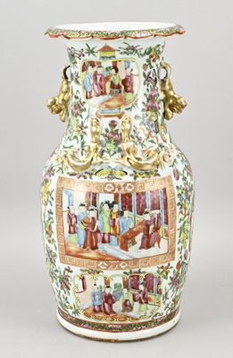 un grand vase avec un tableau posé sur une table