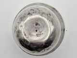 a close up of a silver object on a white surface