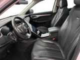 the interior of a car with black leather seats and a tablet on the steering wheel