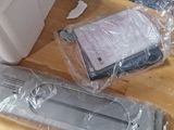 two remote controls on a wooden table next to a box