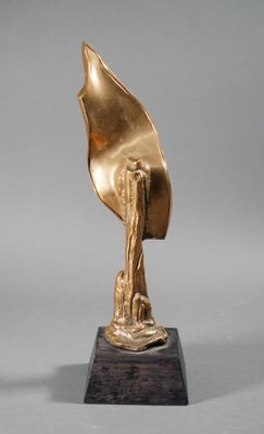bronze sculpture of a hand holding a leaf on a wooden base
