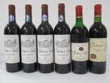 several bottles of wine are lined up in a row
