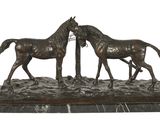 a statue of two horses standing next to each other