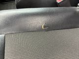 a close up of a seat in a car with a small insect on it