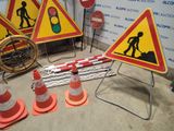 many construction signs and cones on the ground