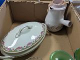 a box full of dishes and cups and a teapot