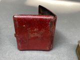 a small red case sitting on a table next to a pair of shoes