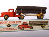 a toy truck with a load of logs on the back of it