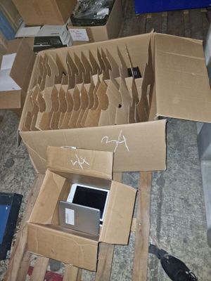 a pile of cardboard boxes with a computer inside of it