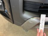 a hand that is holding a stick with a sticker on it