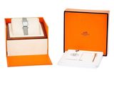 an orange box with a watch inside of it on a white surface