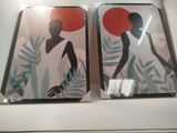 two framed pictures of a woman with a red sun on them