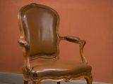 chair in a room with a red wall and a brown wall