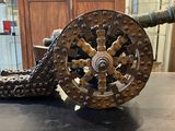 a cannon on a table with a chain attached to it