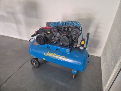 a blue air compressor sitting on top of a blue cart