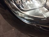 a close up of a car ' s headlight on the street