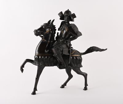 a statue of a man riding a horse on a white background