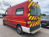 a red van with yellow and red stripes parked in a parking lot