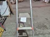 a ladder that is sitting in the middle of a warehouse