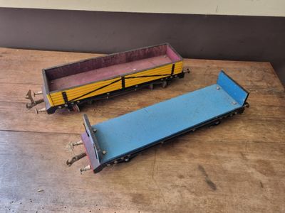 two toy trains sitting on a table next to each other