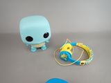 a blue and yellow toy and headphones on a table