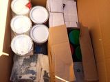 a cardboard box filled with cans of paint and other items