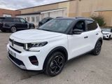 a white suv parked in a parking lot next to a building