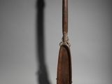 a wooden spoon with a metal handle sitting on top of a table