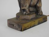 a statue of an elephant that is standing on a base