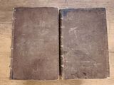 an old book sitting on top of a wooden table next to a pair of scissors