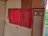 a small bed in the corner of a small room