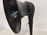an old fashioned black speaker on a white table with a white background