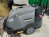 a machine that is sitting on the sidewalk next to a trash can