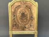 an ornately decorated fireplace screen with a bird on it
