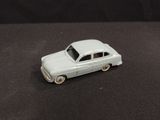 a toy car that is sitting on a black surface