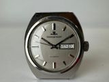 a close up of a watch on a white surface