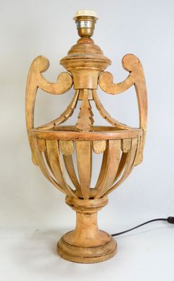 a wooden lamp that is on a white surface