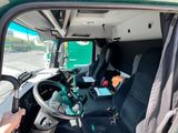 a man that is sitting in the driver ' s seat of a truck