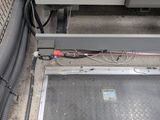 a drain in the floor of a building with a hose attached to it