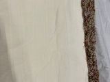 two pieces of white fabric with brown fringes on them